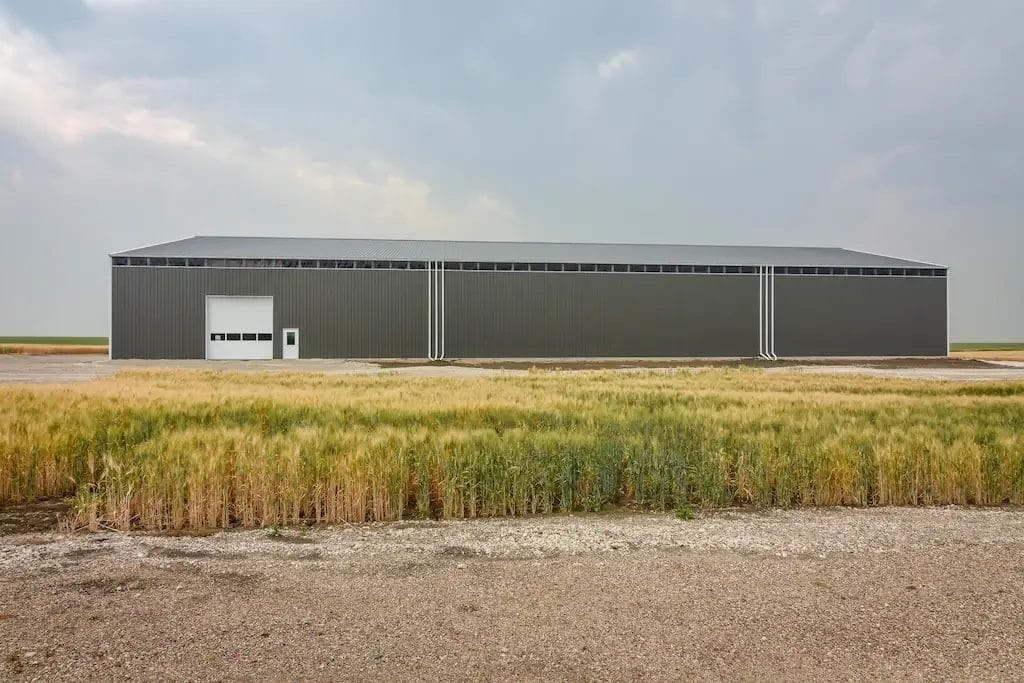 200' long pole barn machine shed with wall light panels