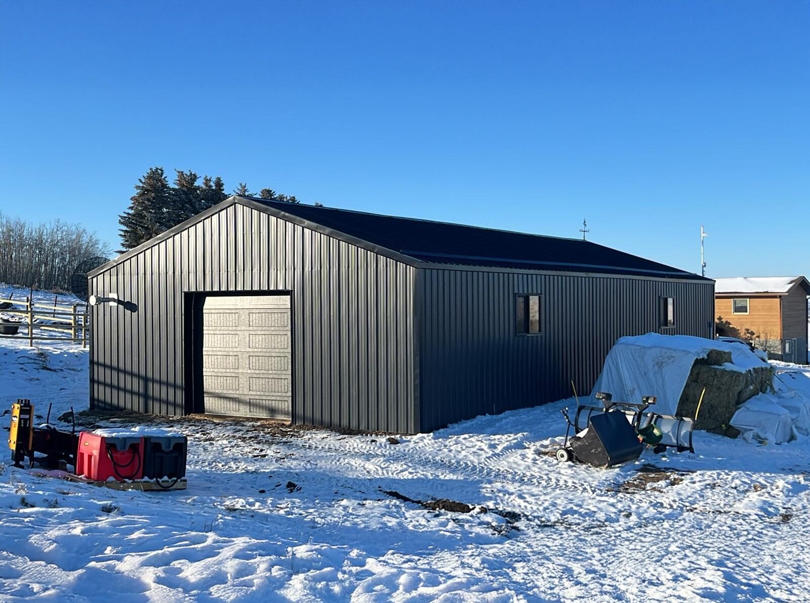 Renovated post frame building to repair metal siding and access doors with modern features