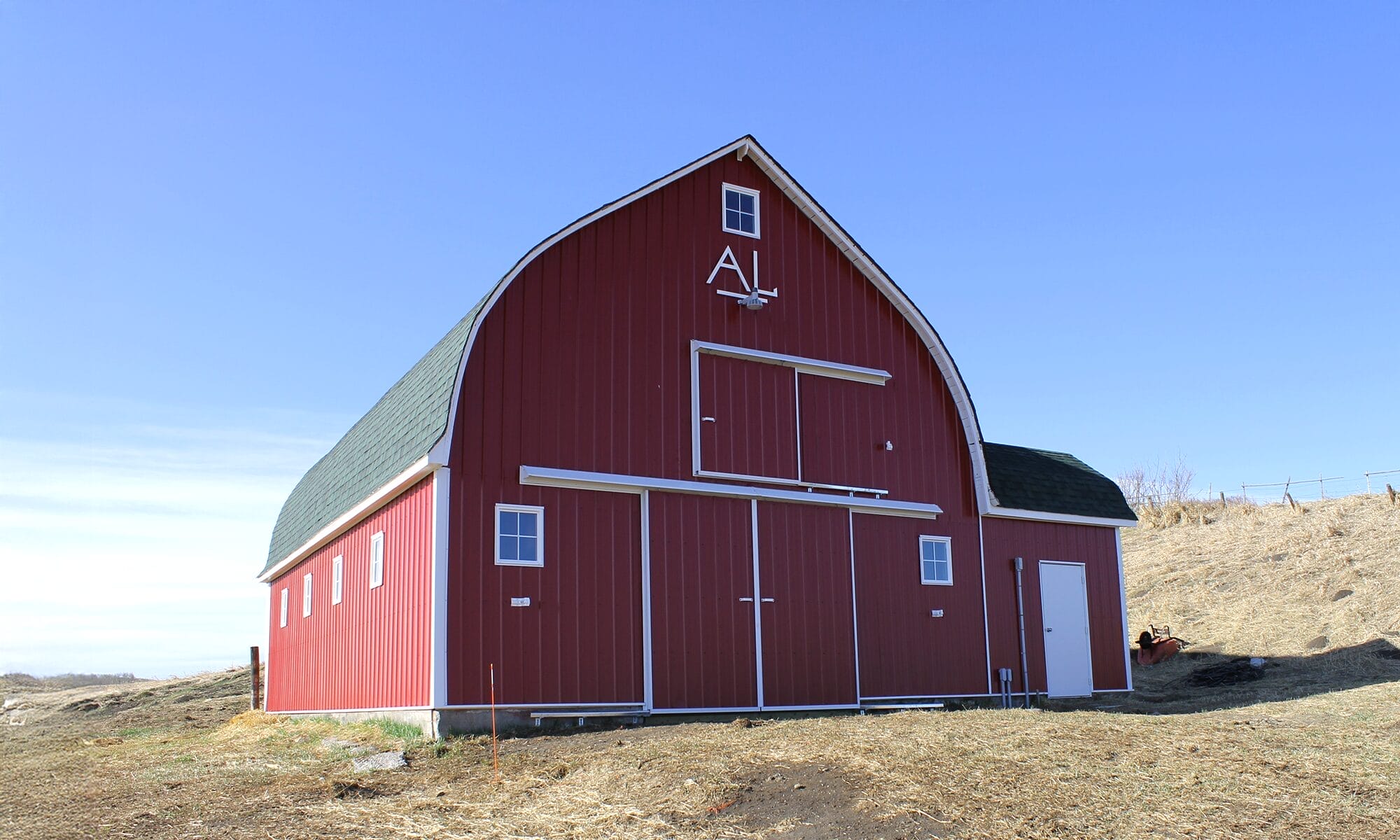 Classic red barn after renovation with updated siding and roofing