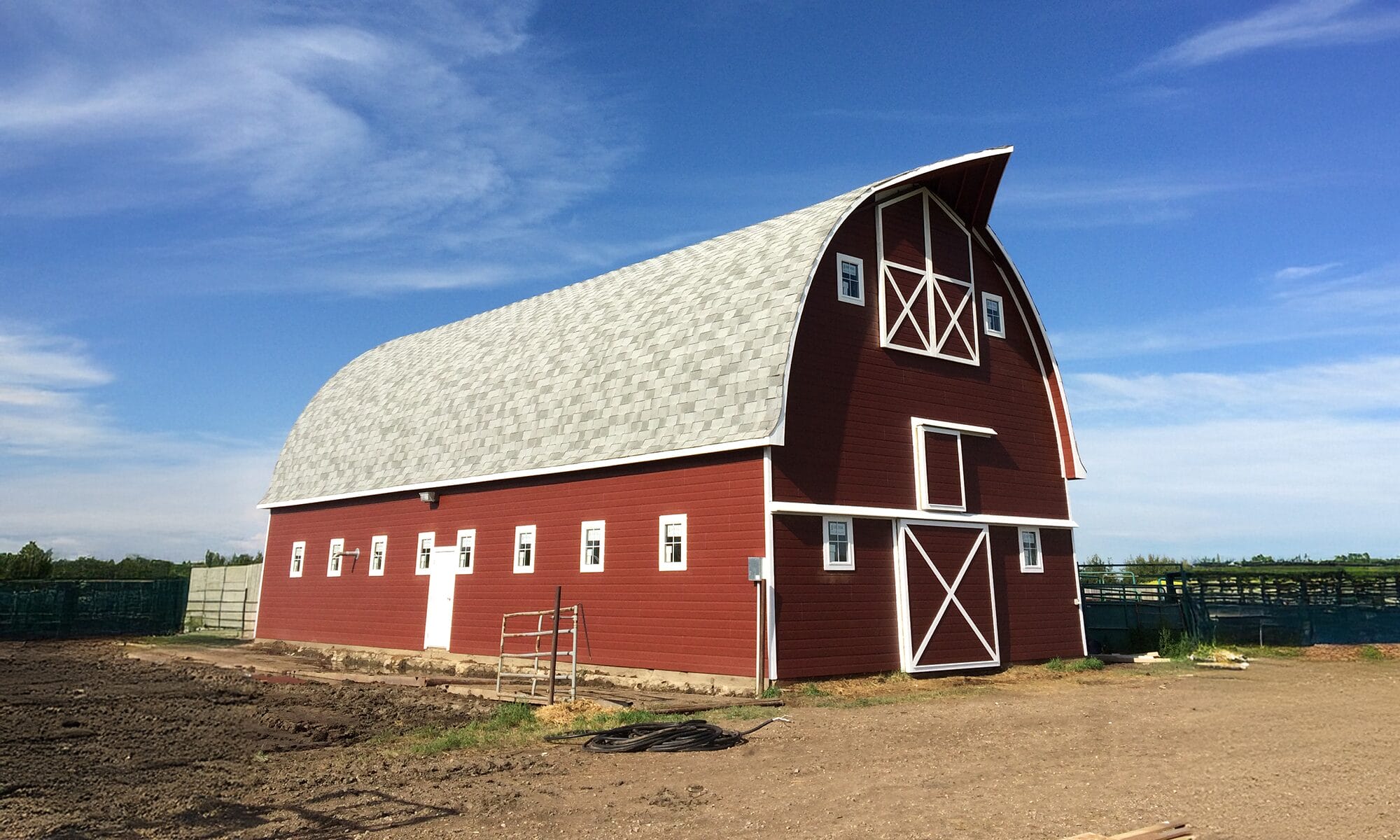 Renovated and repaired classic barn with fresh metal cladding, trim, and a beautifully preserved gambrel roof