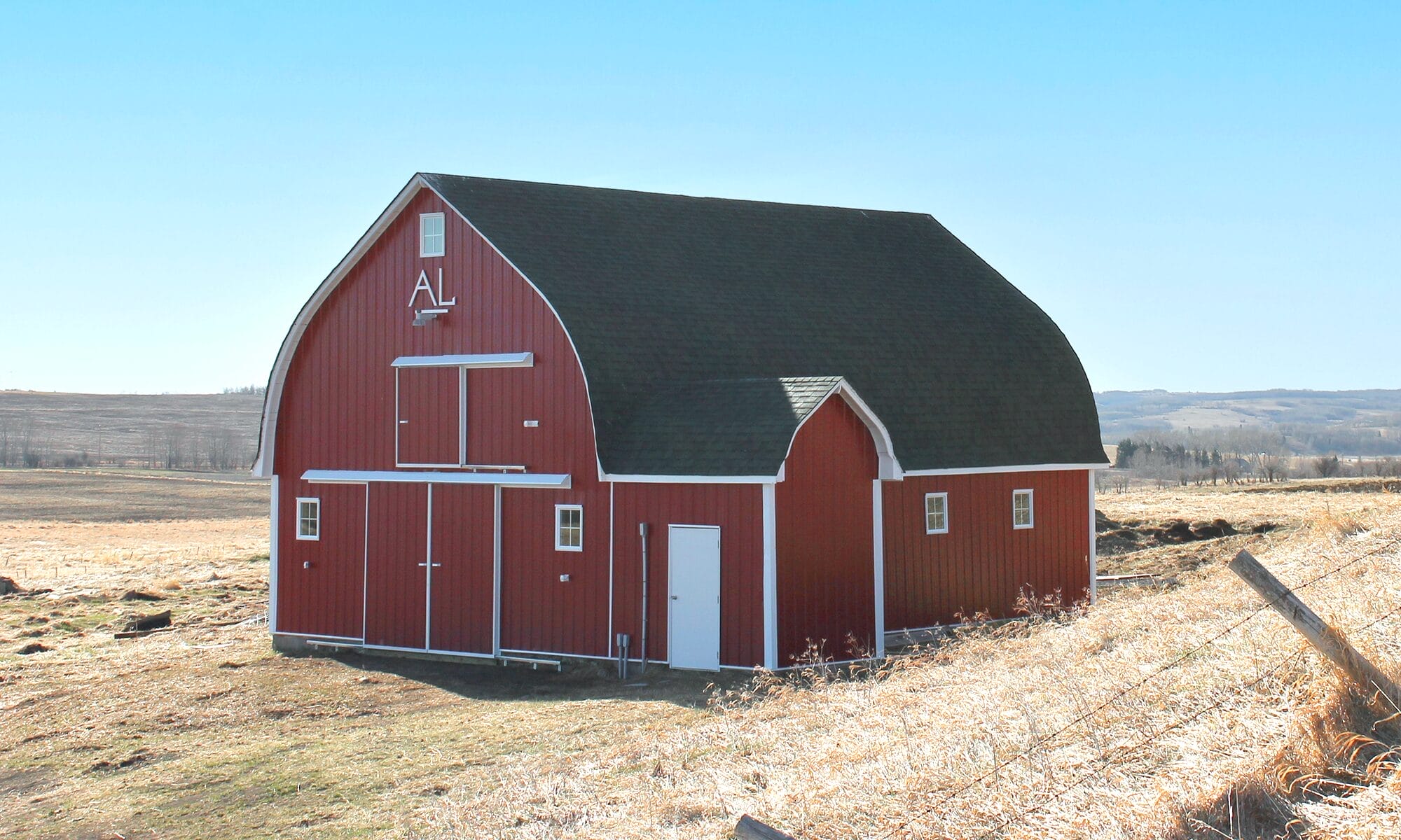 Classic restored red agricultural building renovation project on the country hillside.