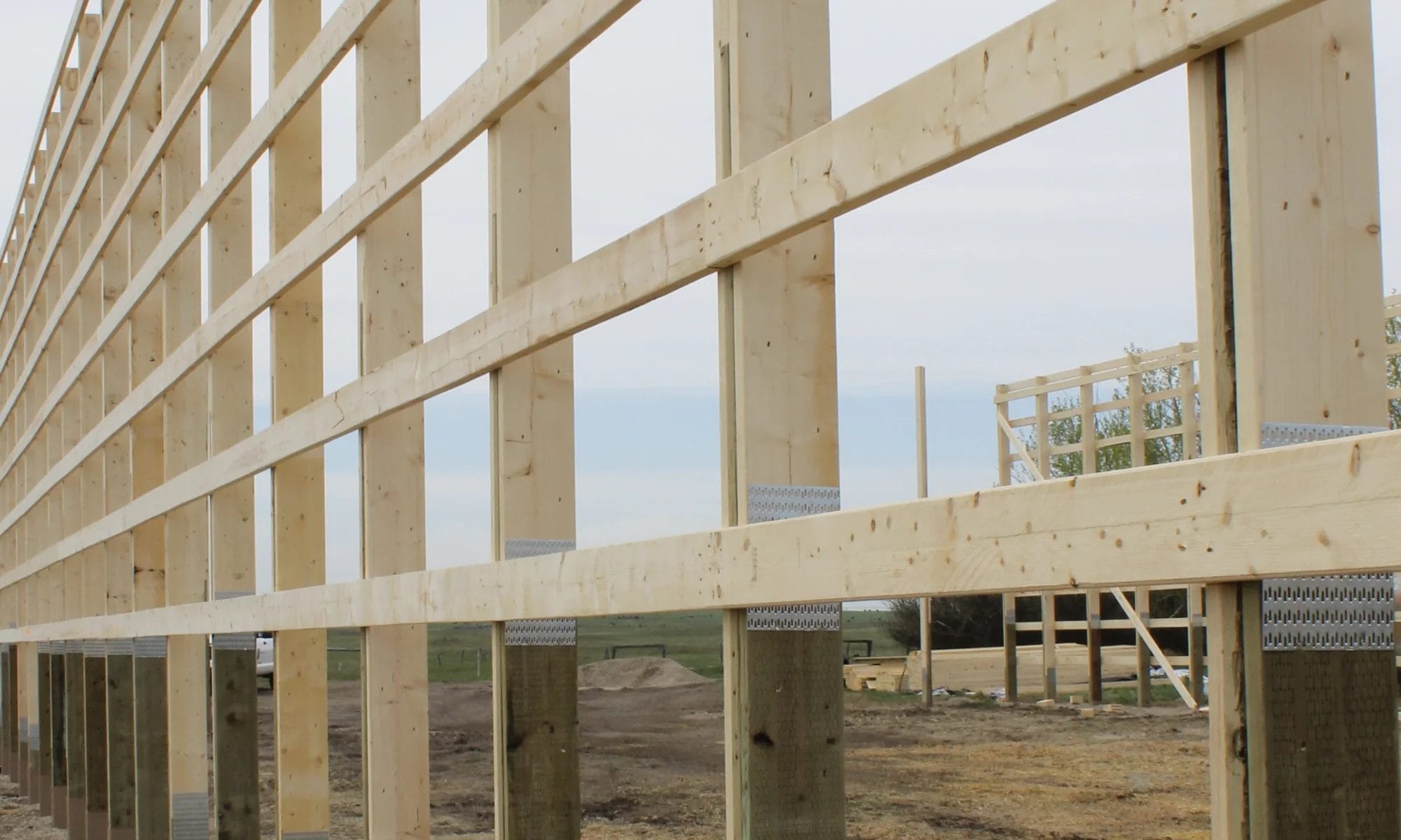 The eave wall of in-progress barndominium shop home construction