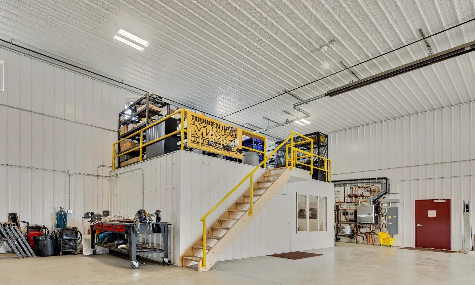 Interior of a commercial building warehouse featuring mezzanine storage and clean, organized interior.
