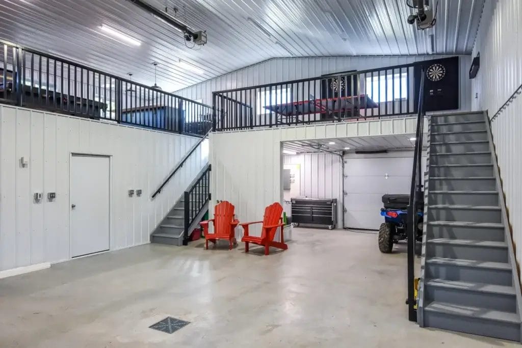 The vaulted ceiling inside a post frame hobby shop helps with natural lighting and providing headroom in the second floor recreation area.