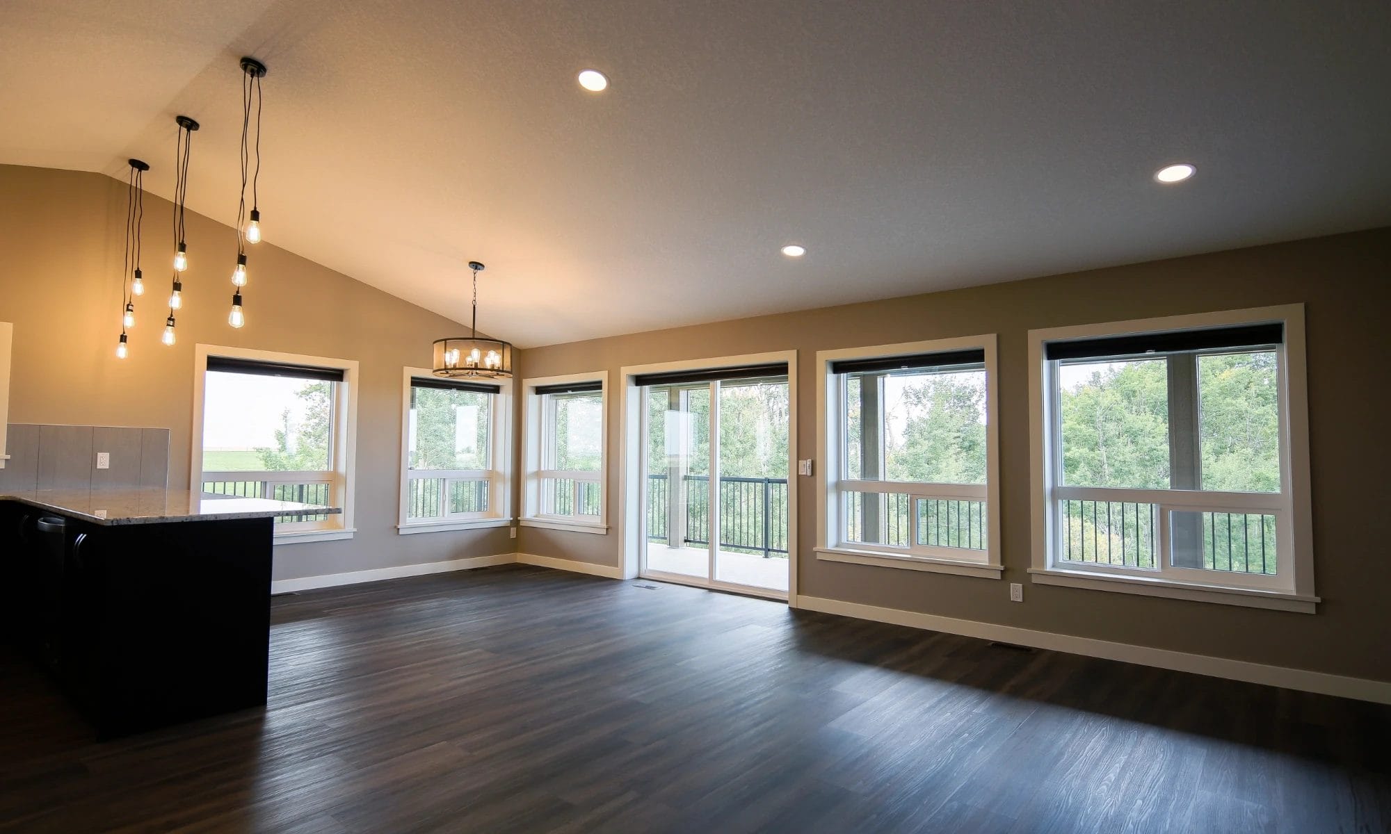 Open-concept interior of a modern barndominium shop home with large windows that provide plenty of natural light.