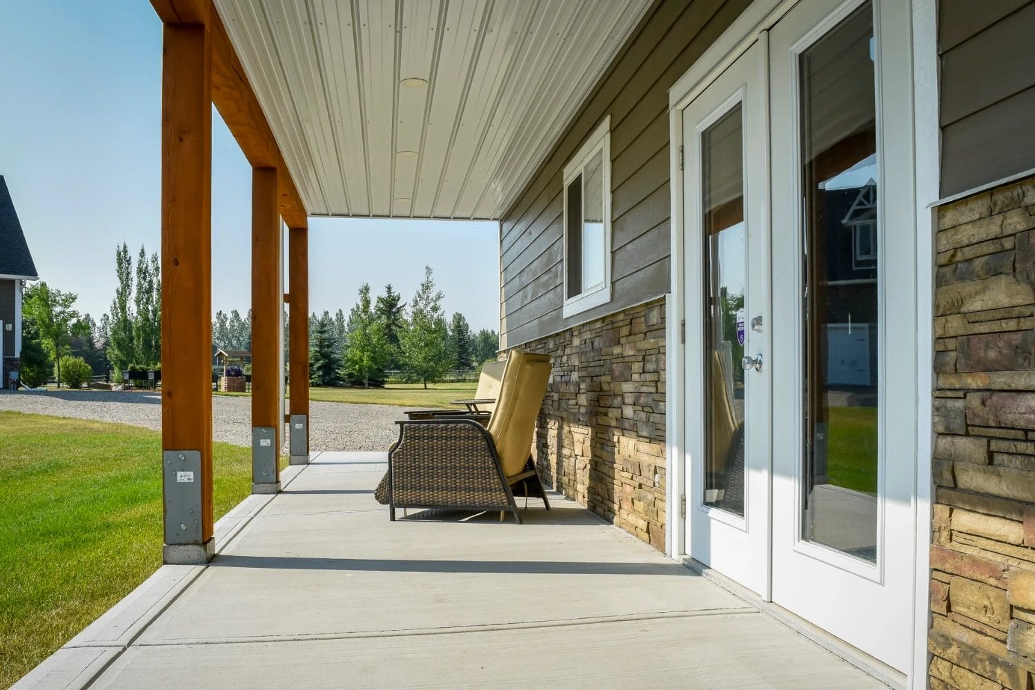 Stone wainscoting, perma-column foundation, and a hardie board exterior give durability to the post frame garage.