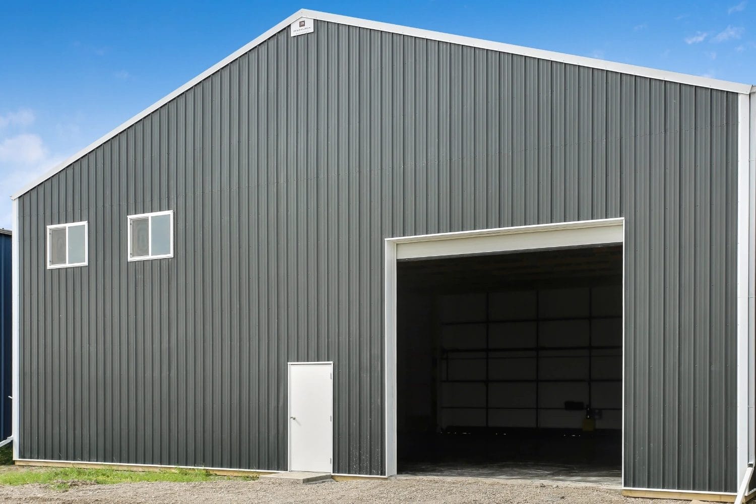 An additional overhead door on the back of an airplane hangar supports the movement of tools and other items.