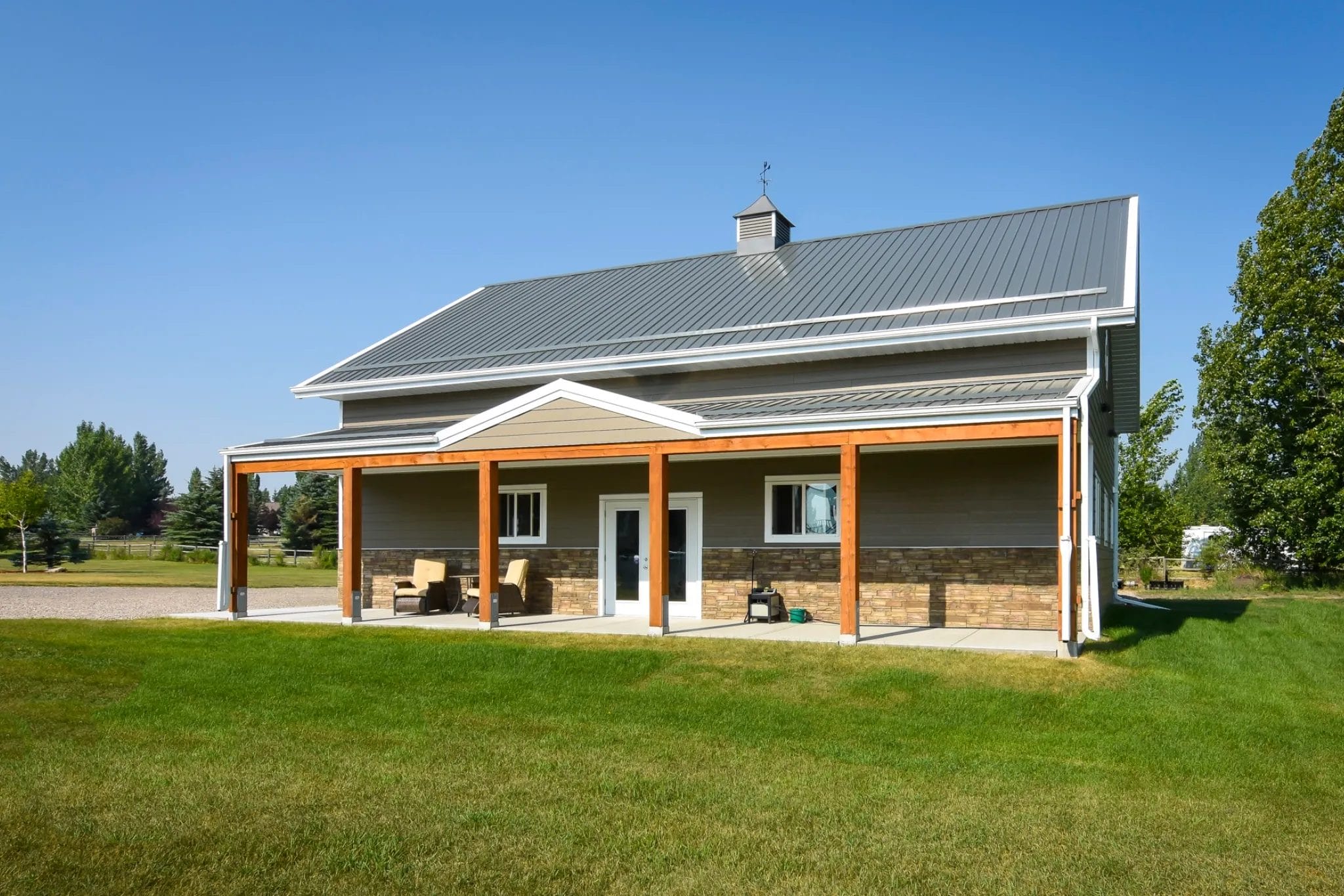 Mid gable details and a cupola were incorporated into this post frame garage to elevate the exterior to fit seamlessly on a high-end property.