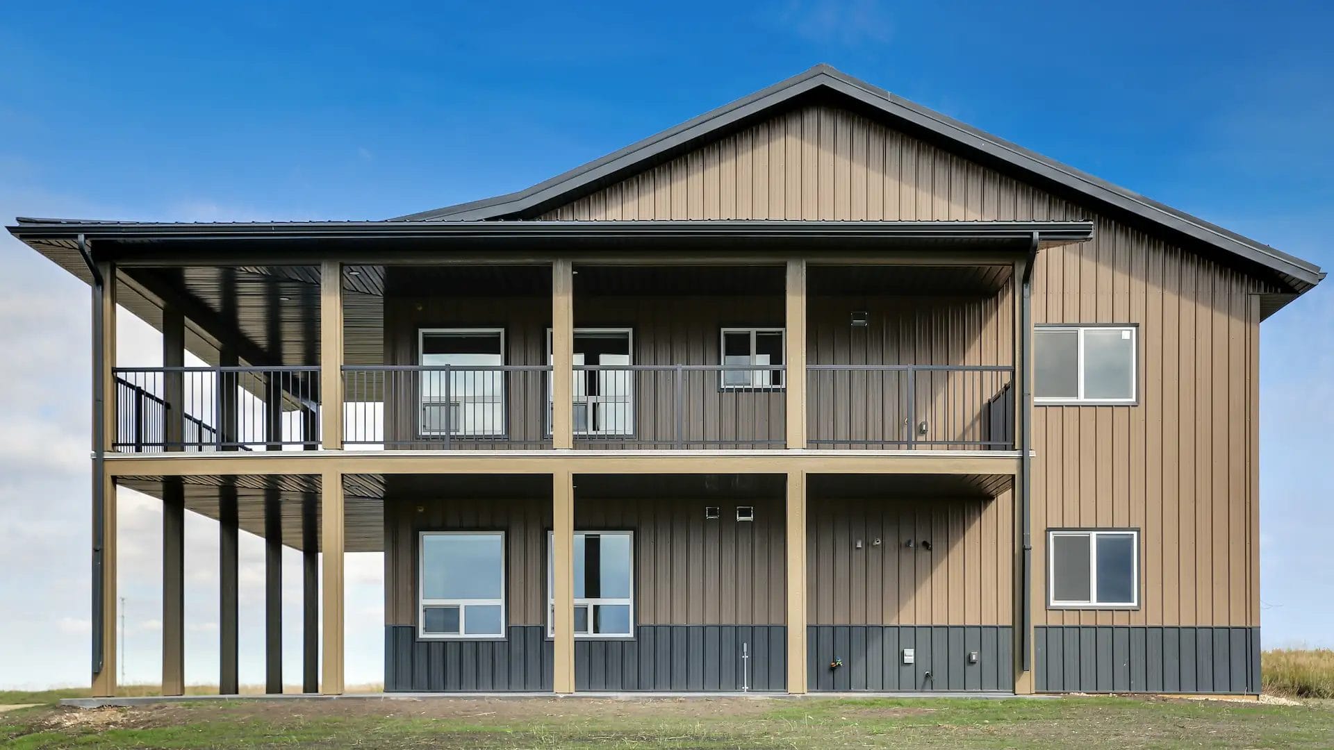 Wrap around deck on a two story barndominium with views of the countryside