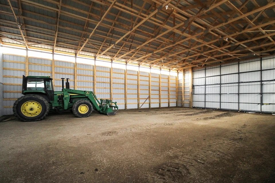 Tractor inside a 48' x 108' post frame farm building