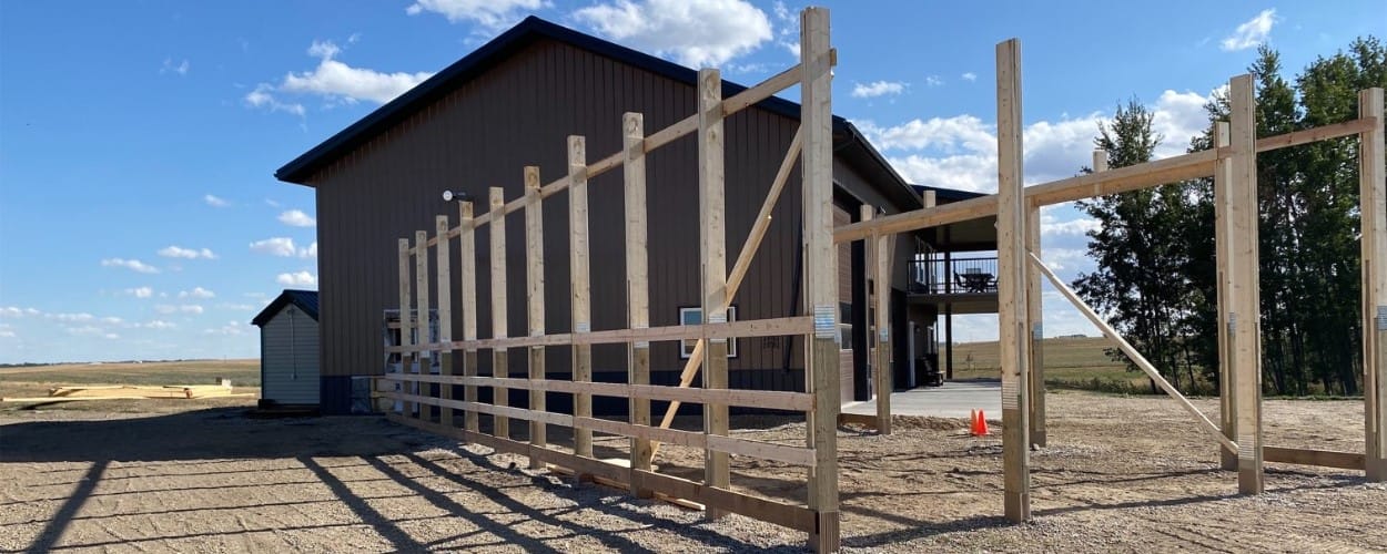 A progress image of a post frame building undergoing a renovation to expand the building