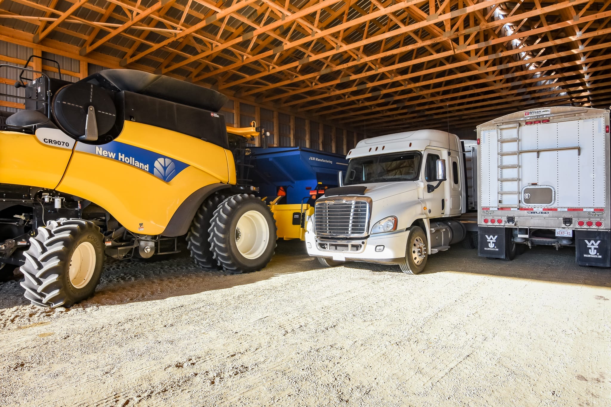 A variety of farm equipment stored indoors to prevent weather-related damages