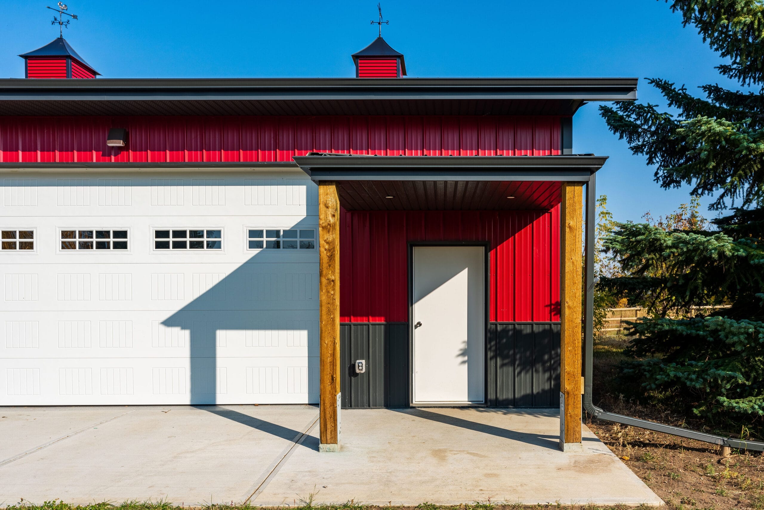On a custom pots frame acreage outbuilding, a lean-to shelters the entryway from the elements