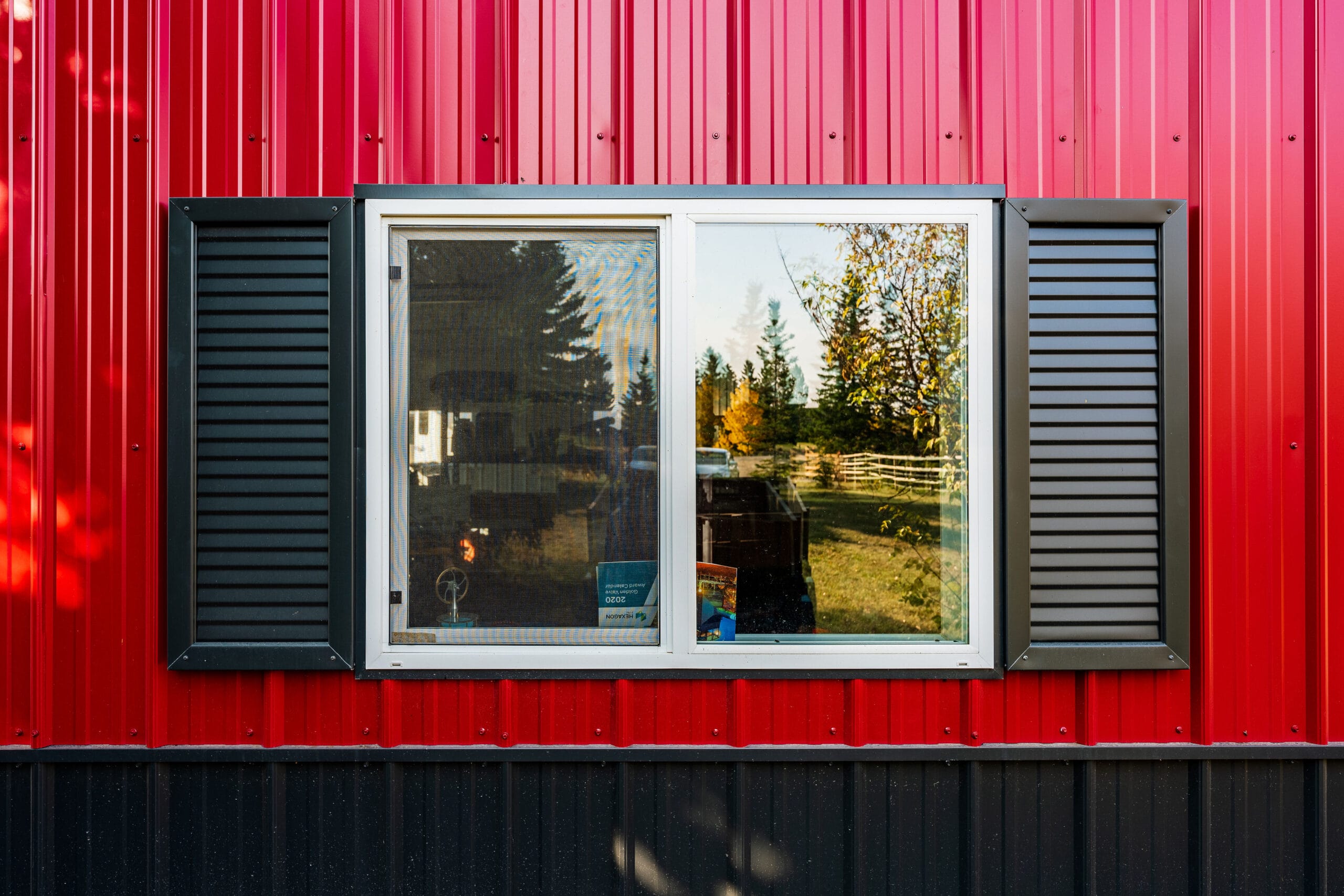 Faux window shutters on the exterior of a custom acreage outbuilding