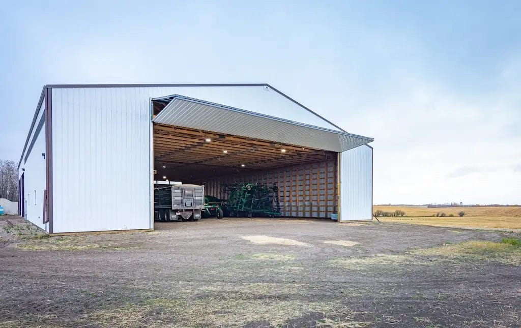 Large 50' wide bi-fold door on a large pole barn machine shed fully opened