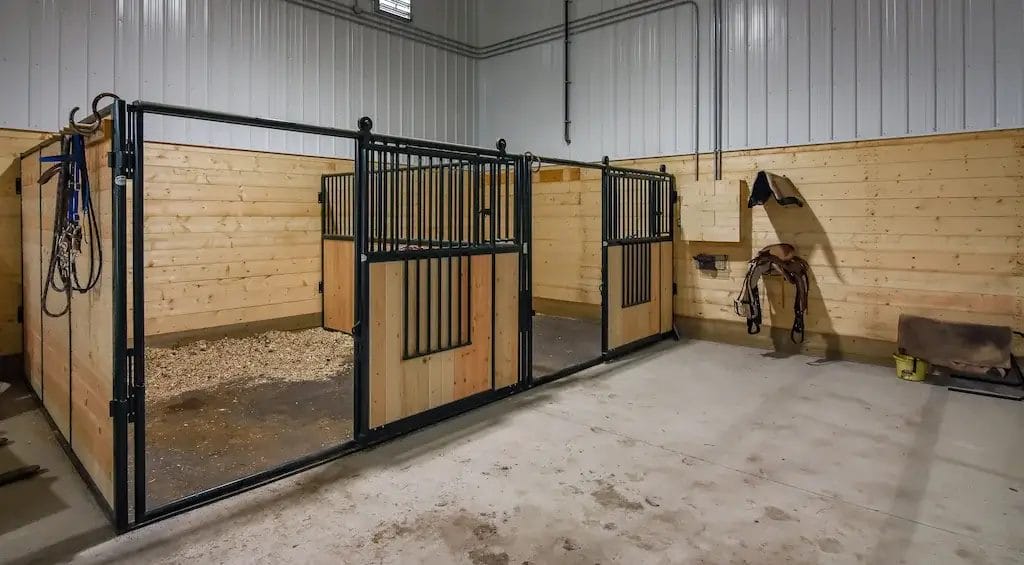 Two horse stalls inside a riding arena