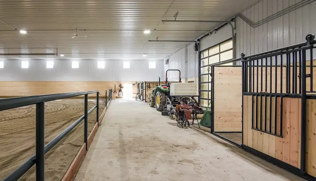 Loafing area inside a post frame riding arena for horses