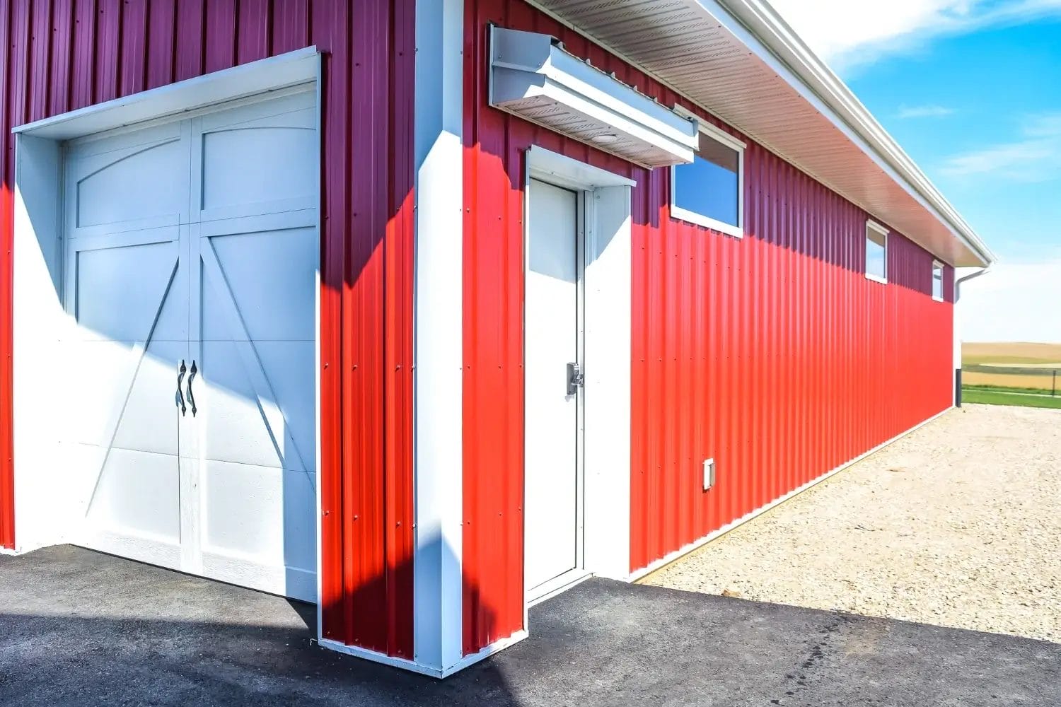 A close up shows the eyebrow dteail over a walk door that leads inside a custom hobby shop