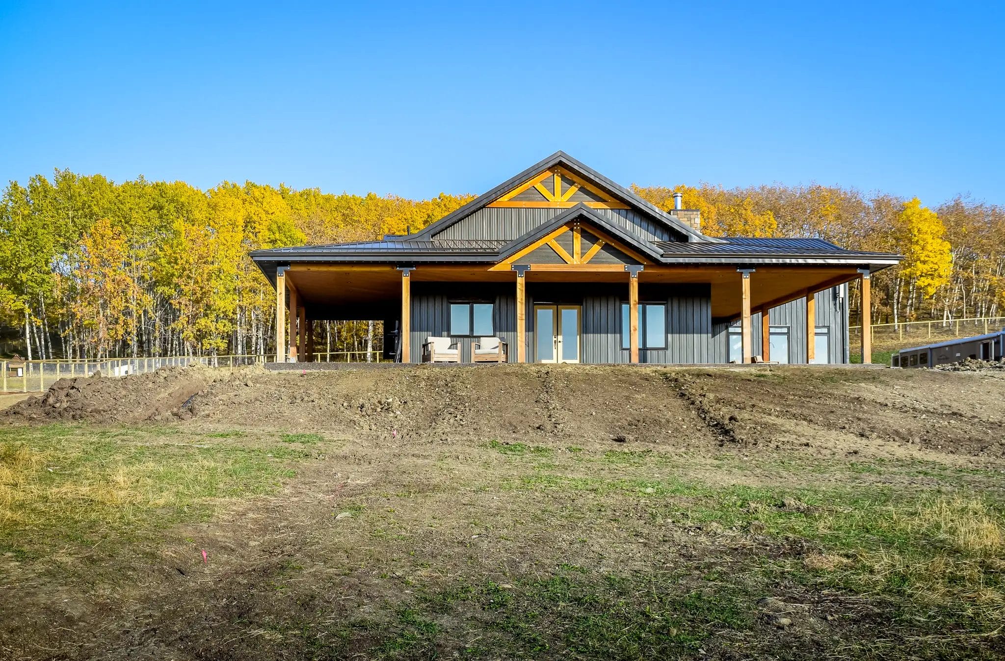 Small barndominium exterior with premium detail finishes like exposed timbers.