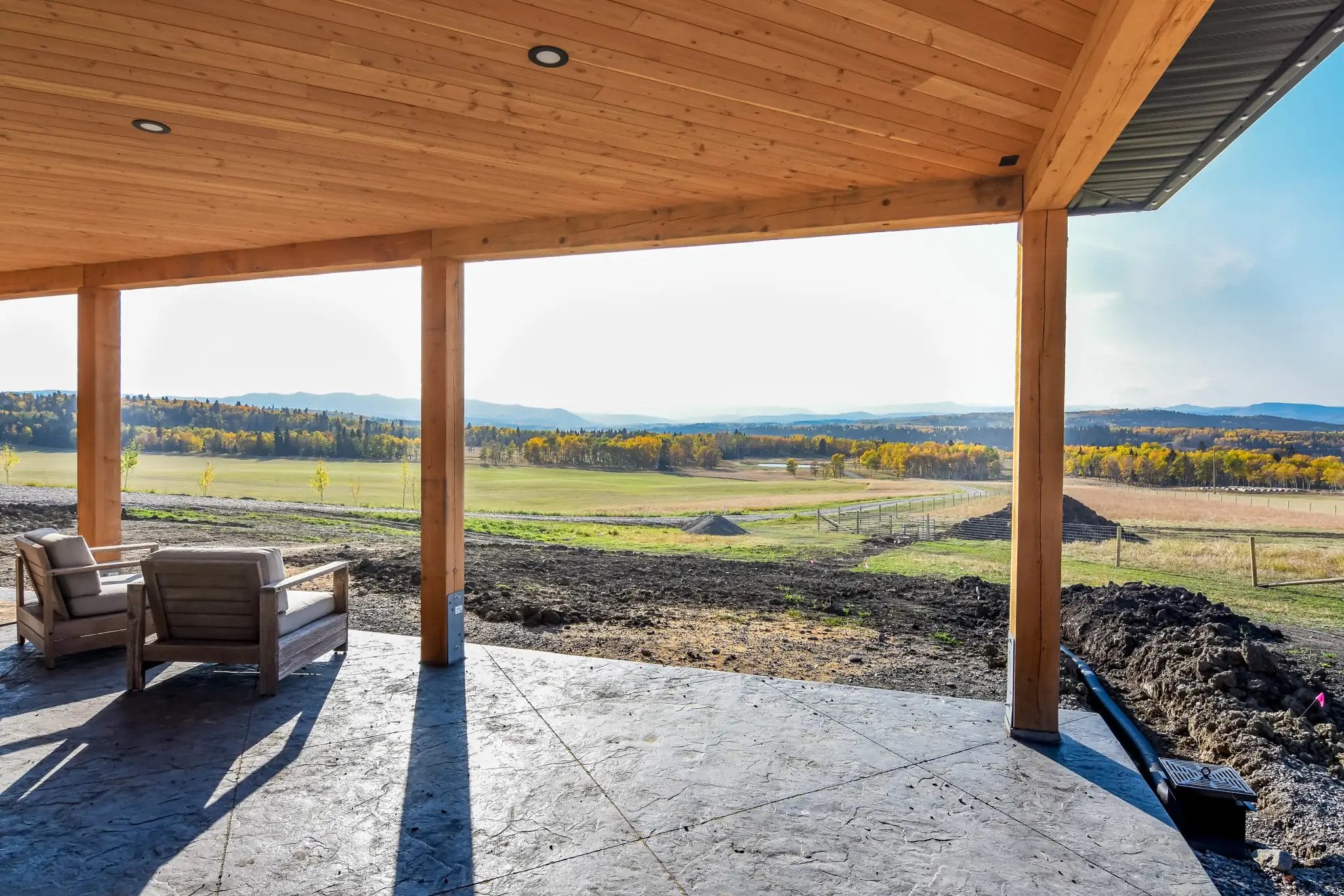 Scenic countryside and foothill view from underneath a barndominium with wrap around porch