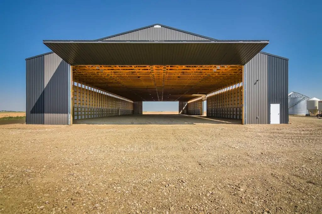 Two opposing bi-fold doors on a post frame agricultural storage building create pull through access