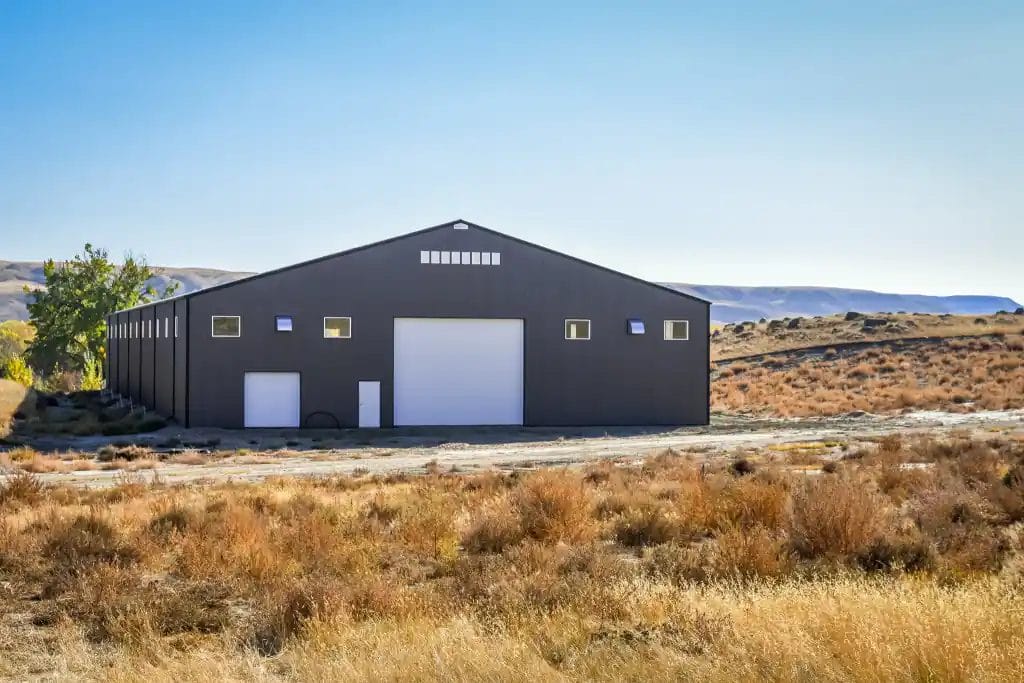 Large post frame buildings riding arena in the foothills of Alberta