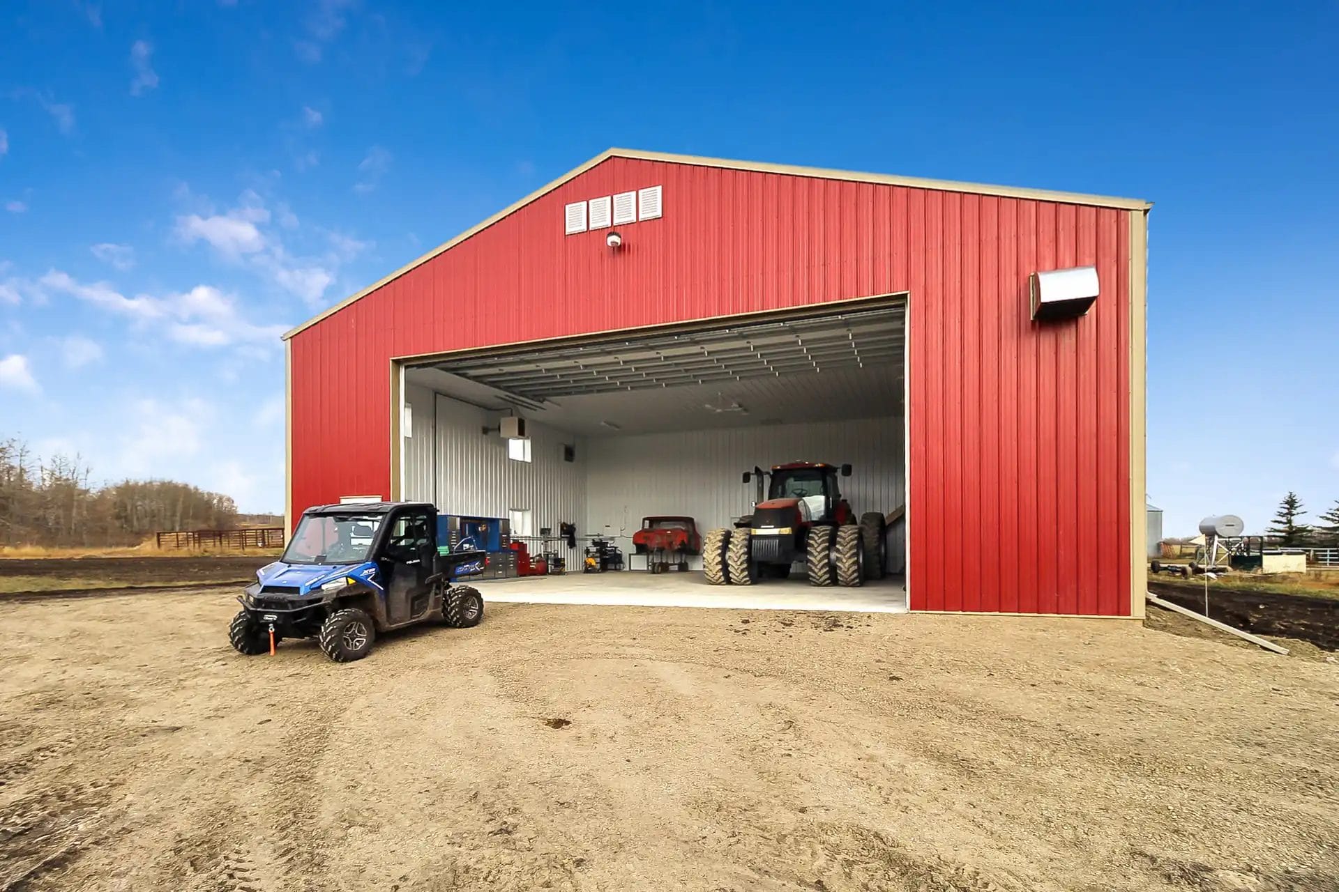Heated farm shop with exhaust fan and intake damper ventilation