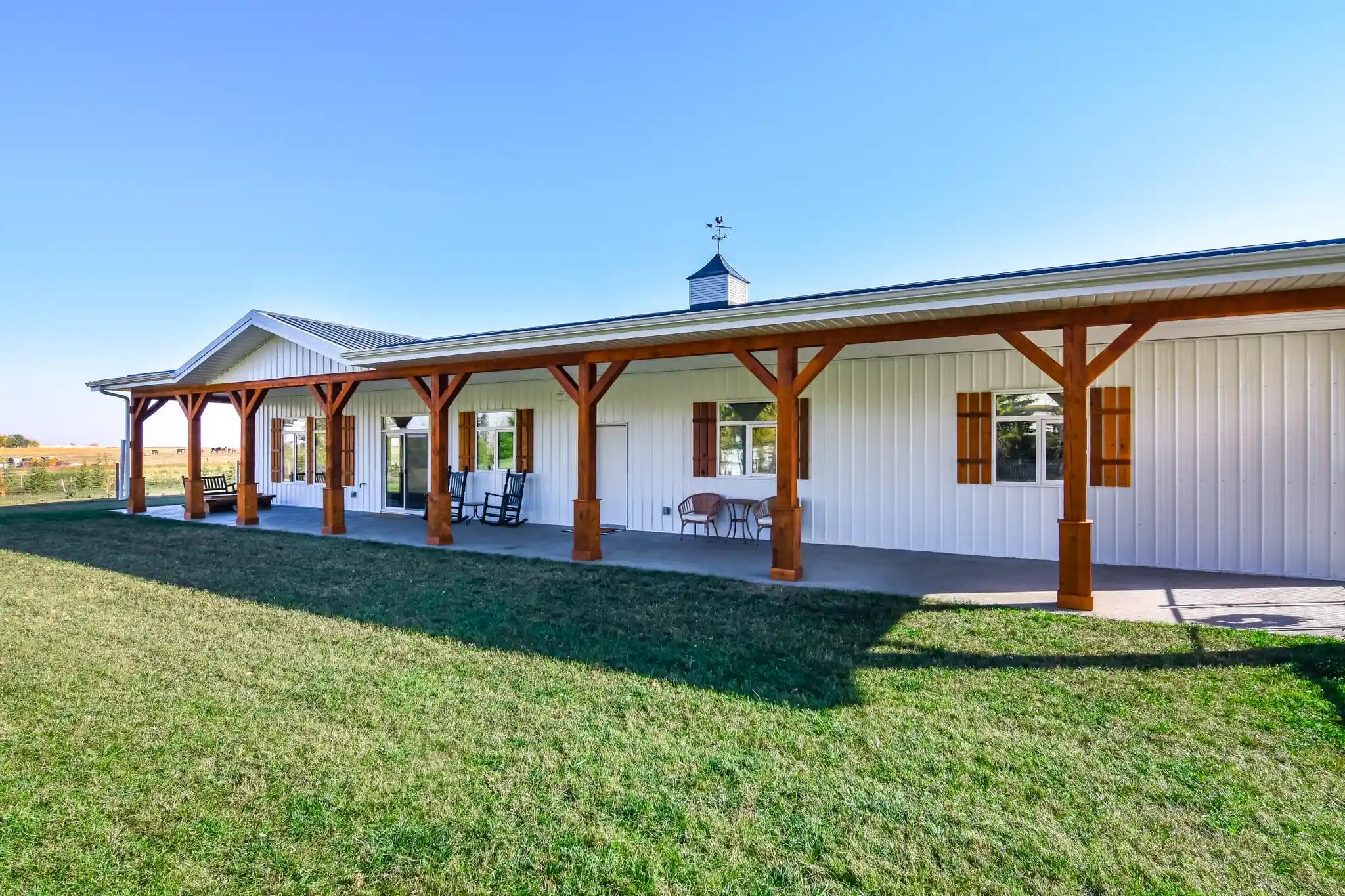 Wood-tone exterior details on a rustic barndo with white metal siding